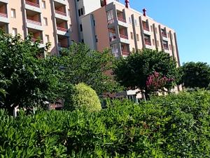 a tall building with a lot of trees and bushes at CONDOMINIO CESANO MARE in Marotta +59 photos