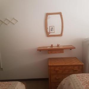 a bathroom with a sink and a mirror on a wall at CONDOMINIO CESANO MARE in Marotta