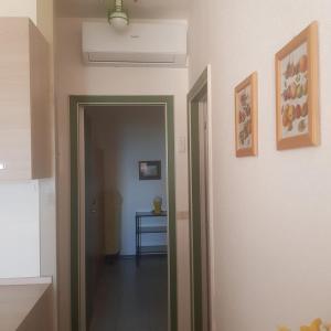 a hallway with a door leading to a room with a table at CONDOMINIO CESANO MARE in Marotta