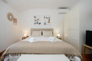 a bedroom with a bed with two towels on it at Guests house DaLi in Rovinj