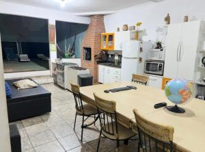 a kitchen with a table and chairs in a room at Hostel Sideral in Campo Grande