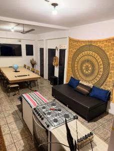 a living room with a couch and a table at Hostel Sideral in Campo Grande