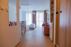 a hallway of a living room with a couch and a table at Студио 8 Уютна Почивка in Hisarya