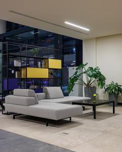 a living room with two couches and a coffee table at TULIP Residences Lviv in Lviv +78 photos