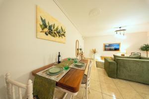 a living room with a table and a couch at Olive Aura in Mytilene