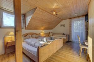 a bedroom with a large bed and a wooden ceiling at Hotel Haus Anna in Bayerisch Eisenstein +31 photos