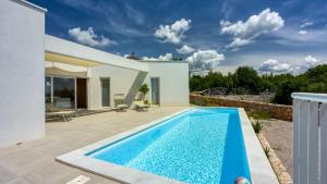 a swimming pool in the backyard of a villa at Villa Menta 4 by Villas Guide in Malinska