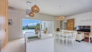 a kitchen and living room with a table and chairs at Villa Menta 4 by Villas Guide in Malinska