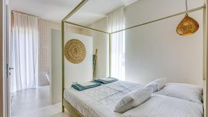 a bedroom with a white bed with two towels on it at Villa Menta 4 by Villas Guide in Malinska +20 photos