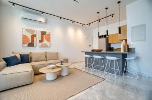 a living room with a couch and a kitchen at Prestige 504 2 BED in Paphos