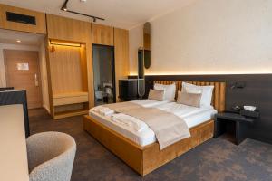 a bedroom with a large bed and a television at Element in Alba Iulia +69 photos