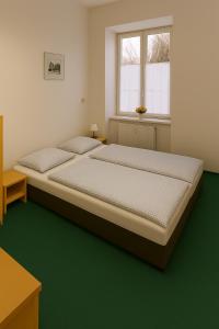 a bedroom with two beds and a window at Pension na hranici in Železná Ruda