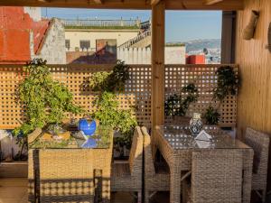a table and chairs on a balcony with a view at RIAD AMR in Tangier