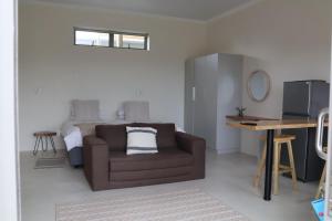 a living room with a couch and a bed at Sarah's Place -Stilbaai in Stilbaai