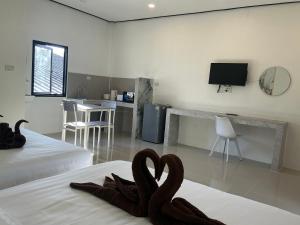 a bedroom with two swans sitting on a bed at Lanta Beautiful beach house 1 in Phra Ae beach