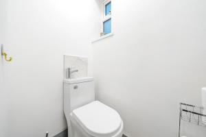 a bathroom with a white toilet and a window at Contractor-friendly Home in Stoke with Free Parking in Stoke on Trent +12 photos