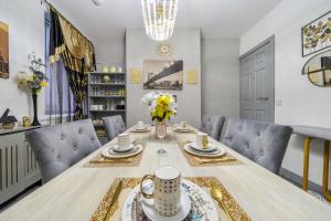 a dining room with a table and blue chairs at Contractor-friendly Home in Stoke with Free Parking in Stoke on Trent