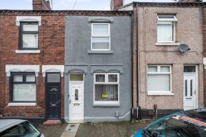 a gray house with a white door and windows at Contractor-friendly Home in Stoke with Free Parking in Stoke on Trent