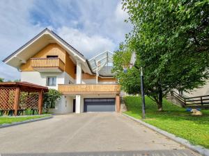 a house with a garage on the side of a street at Green View Kamnik in Kamnik