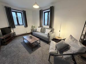 a living room with a couch and a table at Millbrook House Apartments 7 in Milton
