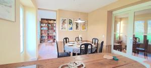 a kitchen and dining room with a table and chairs at La Mondee in Badefols-dʼAns