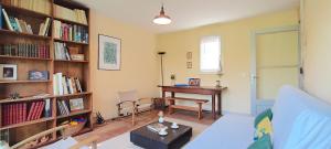 a living room with a desk and bookshelves at La Mondee in Badefols-dʼAns