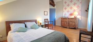 a bedroom with a bed and a table and a chair at La Mondee in Badefols-dʼAns +12 photos