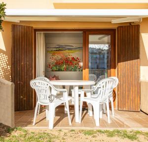 a white table and chairs on a patio at Playa Canadell MAR P primera línea de mar con terraza - WeHost Costa Brava in Calella de Palafrugell