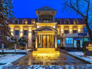 a building with a front door in the snow at Ala Boutique Hotel in Almaty