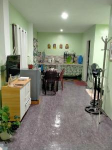 a kitchen and dining room with a table and chairs at Charming Urban Hideout in Puerto Princesa City +11 photos
