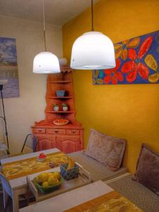 a living room with a table and a painting on the wall at B&B La Veranda - Iseo in Iseo