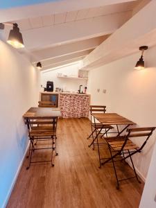 a kitchen with wooden tables and chairs in a room at B&B Morbegno in Morbegno