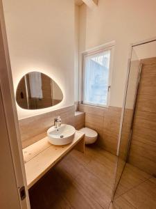 a bathroom with a sink and a mirror at B&B Morbegno in Morbegno +9 photos