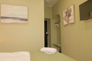a bedroom with a bed and two pictures on the wall at The Tall Trees Hotel in Amlwch +46 photos