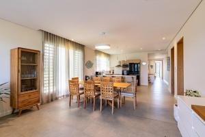 a kitchen and dining room with a table and chairs at Asmara Alora E3 - Beachfront in Rivière Noire