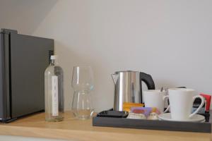 a counter with a bottle of wine and a glass at The Tall Trees Hotel in Amlwch