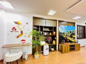 a living room with a desk and a table at Kim's Home in Ba Dinh in Hanoi +19 photos