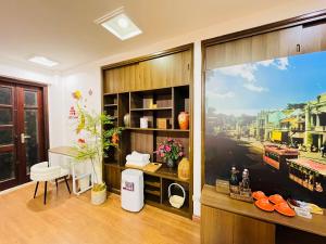a room with a large window and a table and chairs at Kim's Home in Ba Dinh in Hanoi