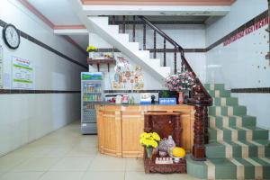 a room with a staircase and a counter with flowers at Nhà Nghỉ Hiếu Thuận in Nhơn Trạch