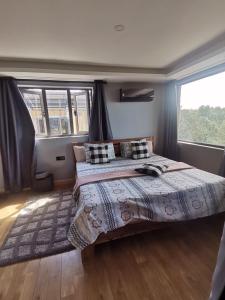 a bedroom with a bed and a large window at The Serenity in Mauritius