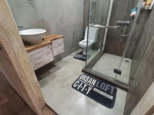 a bathroom with a shower and a sink and a toilet at The Serenity in Mauritius +21 photos