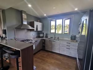 a large kitchen with stainless steel appliances and blue walls at The Serenity in Mauritius