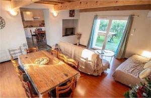 a living room with a wooden table and a couch at Gites Les Granges De Flolie in Beauteville +47 photos