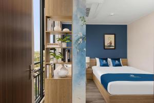 a bedroom with a bed and a book shelf at 3A Hometel Hanoi in Hanoi