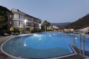 a large blue swimming pool in front of a building at Azure Palm Resort in Oludeniz