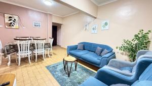 a living room with a blue couch and a table at Moon Homes in Downtown Cairo in Cairo