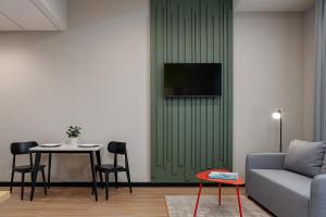a living room with a couch and a table at TULIP Residences Lviv in Lviv