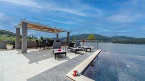 a patio with a table and chairs next to a swimming pool at Villa Franka by Villas Guide in Vela Luka