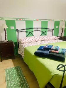 a bedroom with a green bed with two pillows on it at Bosco Stellato in Casteldelci
