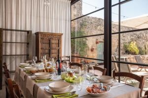 a table with plates and bowls of food on it at Masseria De Li Travaj - Rive del Salento in Patù